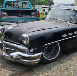 Vintage black classic car with chrome accents and retro styling.