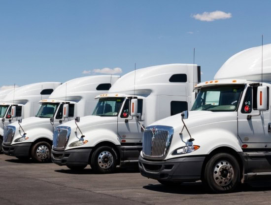 Semi-trucks lined up for maintenance and repair services.