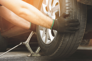 Technician repairing car tire at Butterworth's Service Centre.