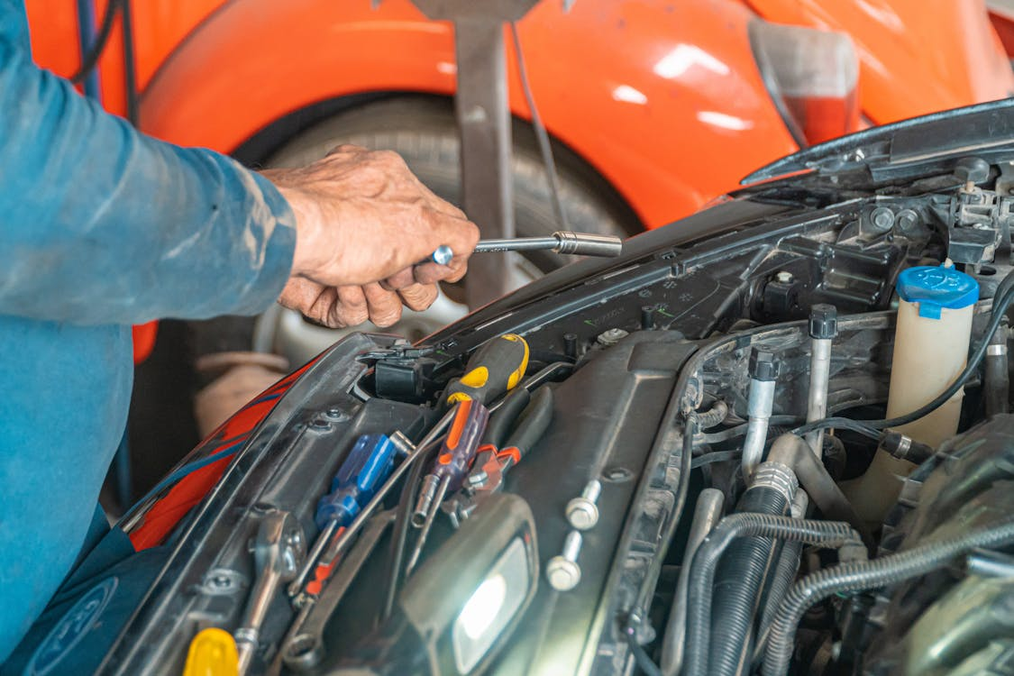 Car engine being inspected for signs of urgent repair needs at Butterworth's Service Centre.