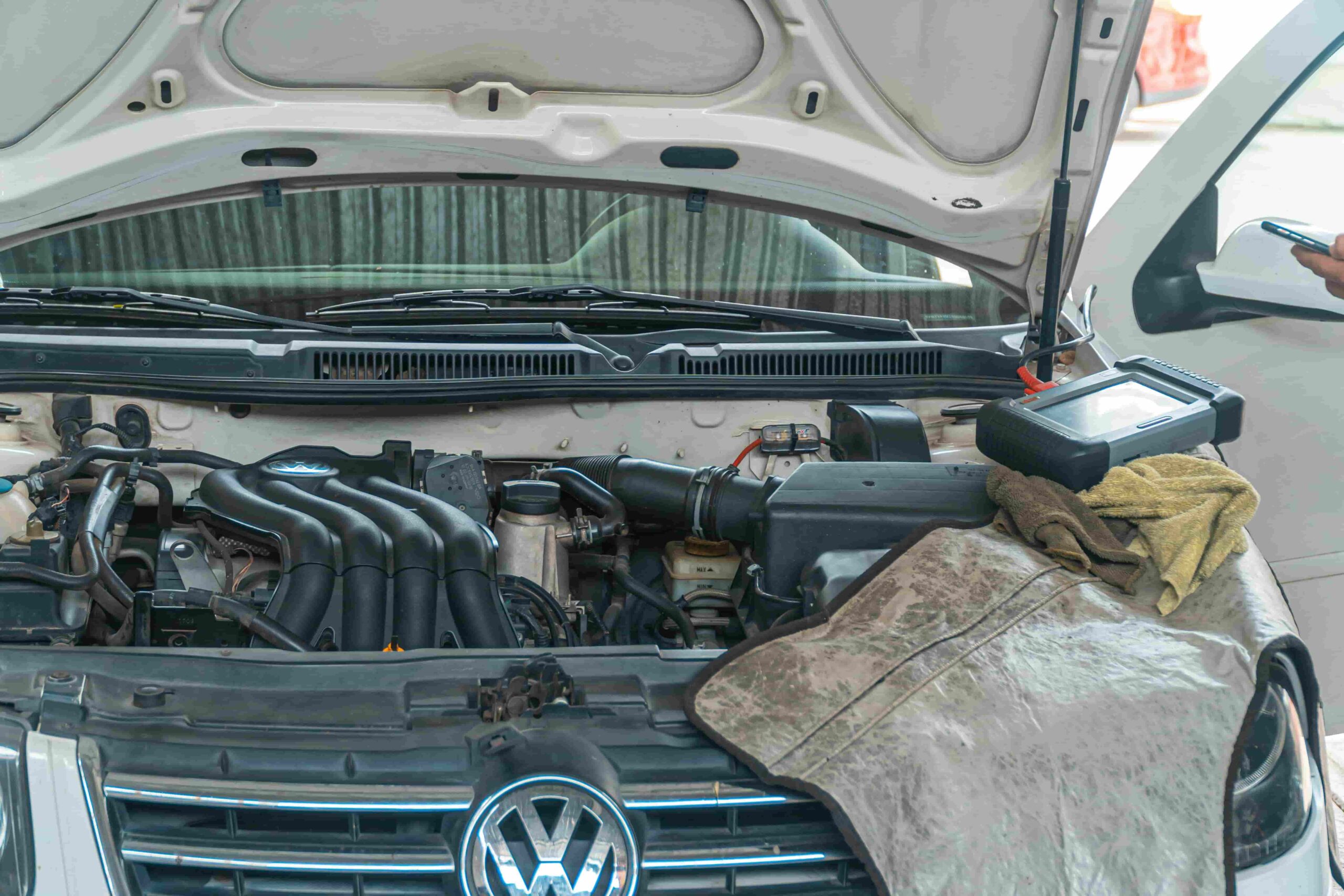 Engine bay of a Volkswagen vehicle during maintenance check.