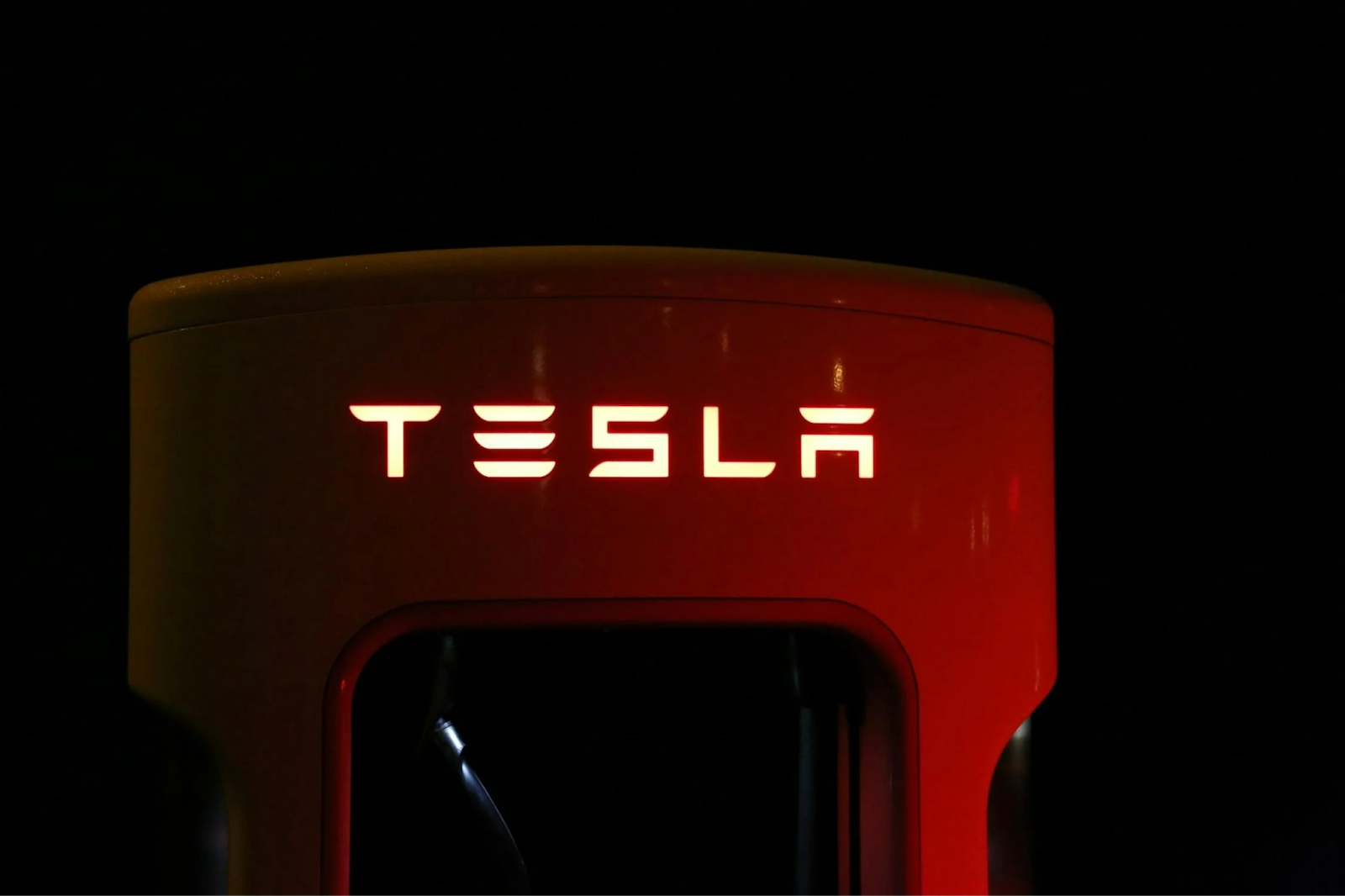 EV charging station with Tesla branding for electric vehicle maintenance.