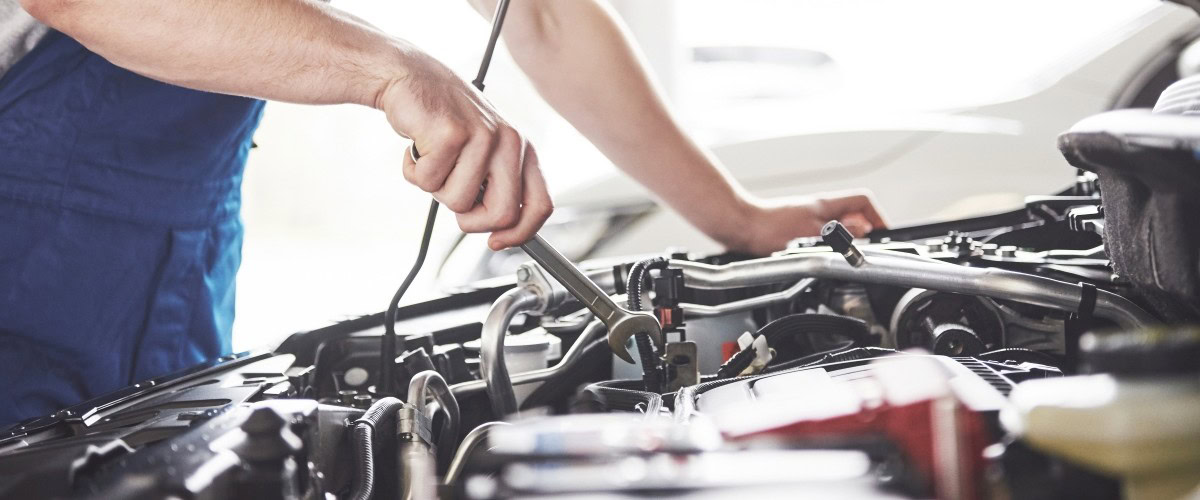 Vehicle engine being diagnosed with advanced tools at Butterworth's Service Centre.