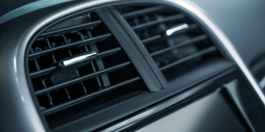Close-up of car air vent showing clean, functional air conditioning grille.