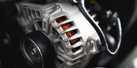 Automotive engine alternator with copper wiring and cooling vents.