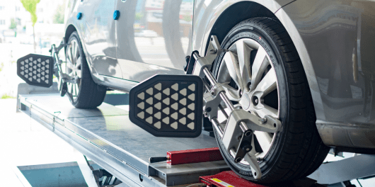 Car wheel alignment being performed at C&D Automotive in Texas.