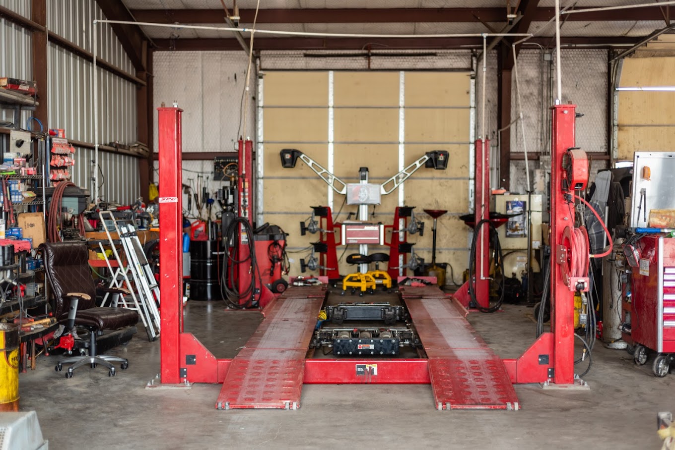 Vehicle lift in an automotive repair shop for car maintenance and repairs.
