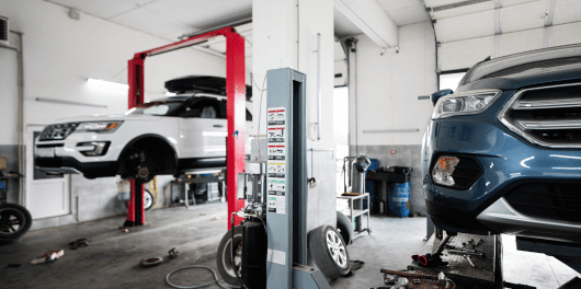 Auto repair shop with vehicles on lifts at C&D Automotive in Texas.