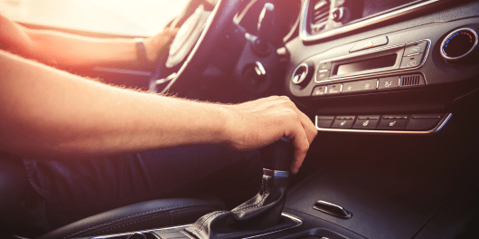 Interior view of a car's dashboard and gear shift at C&D Automotive.