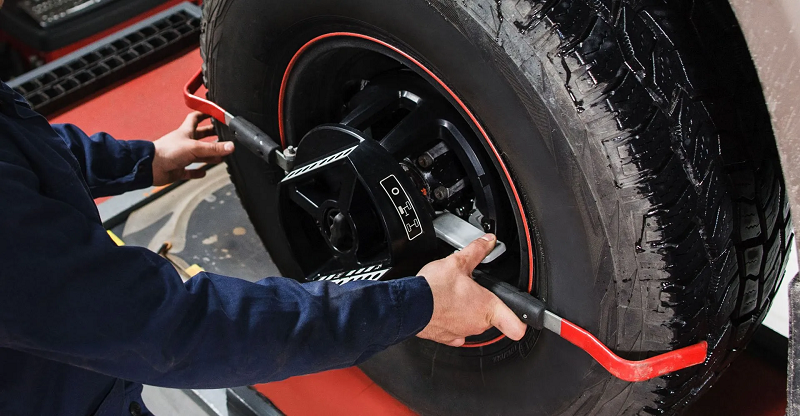 Professional wheel alignment being performed on a vehicle at Capitol Auto Service.