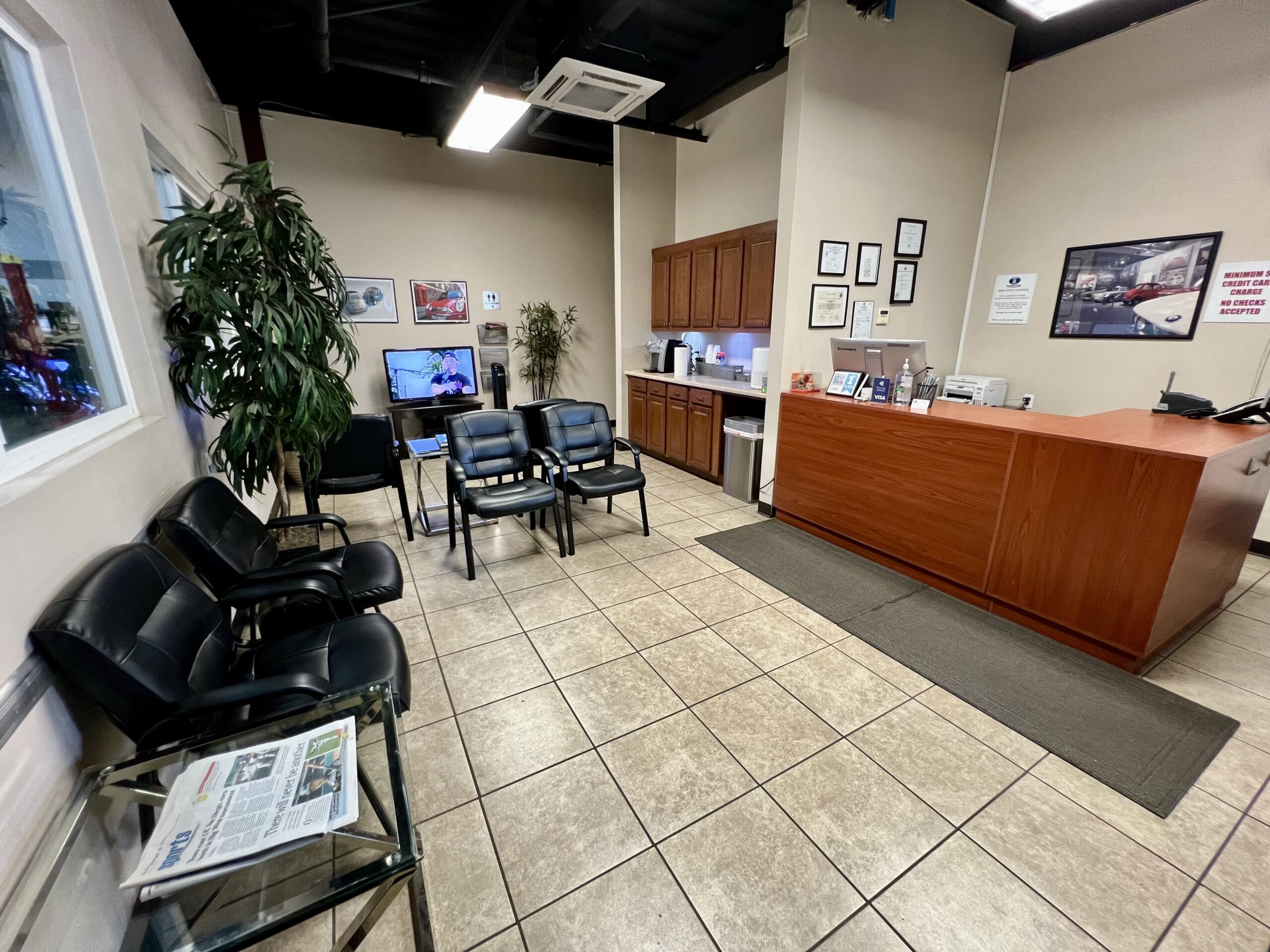 Auto service reception area with seating and informational displays.