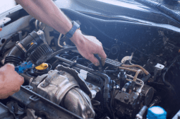 Mechanic inspecting engine components during general repair service.