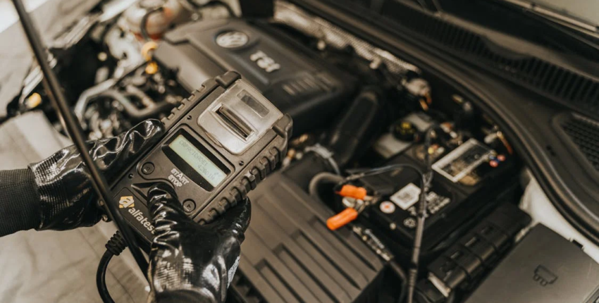 Car battery testing under the hood for vehicle health check.