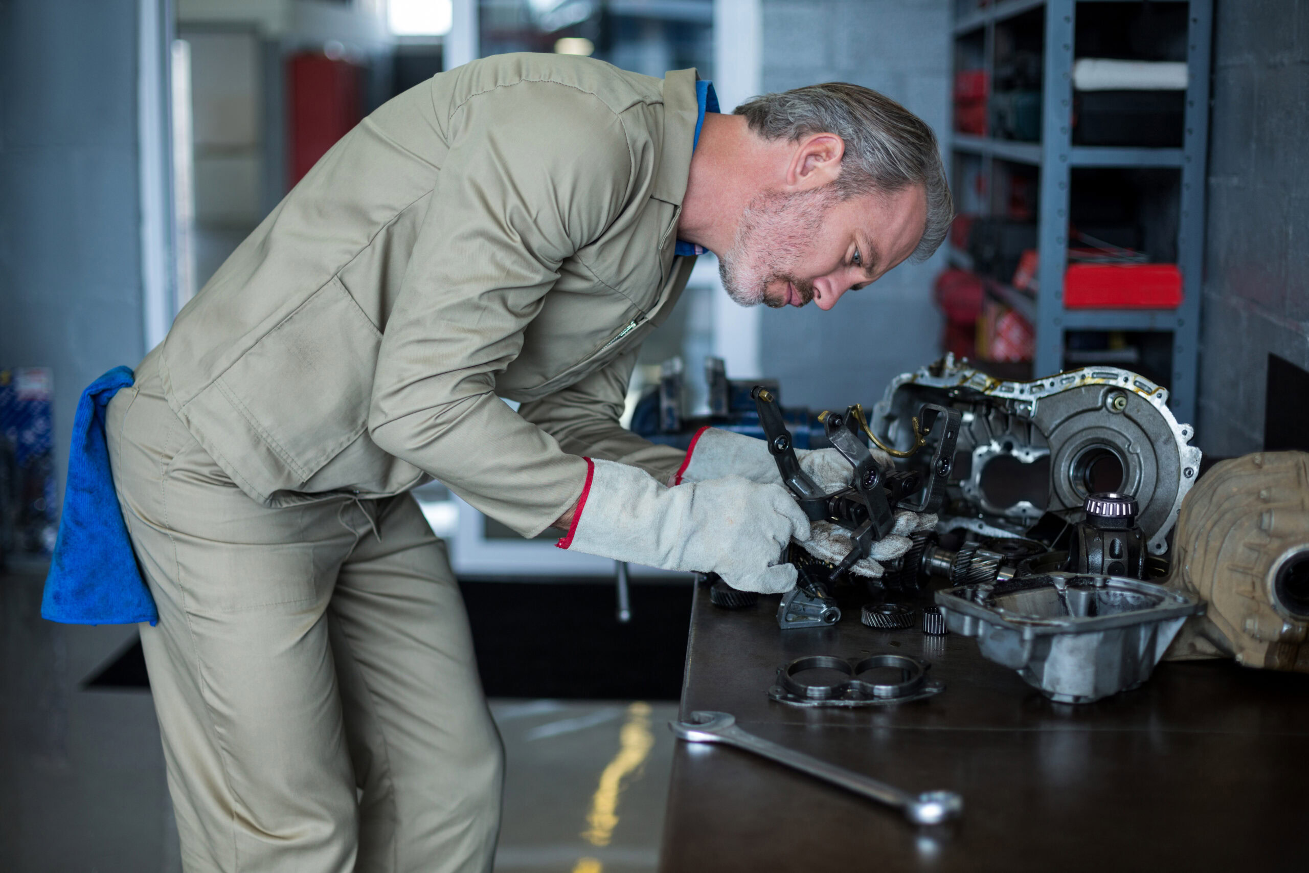Engine repair technician working on diesel engine components at Car Corral Garage.