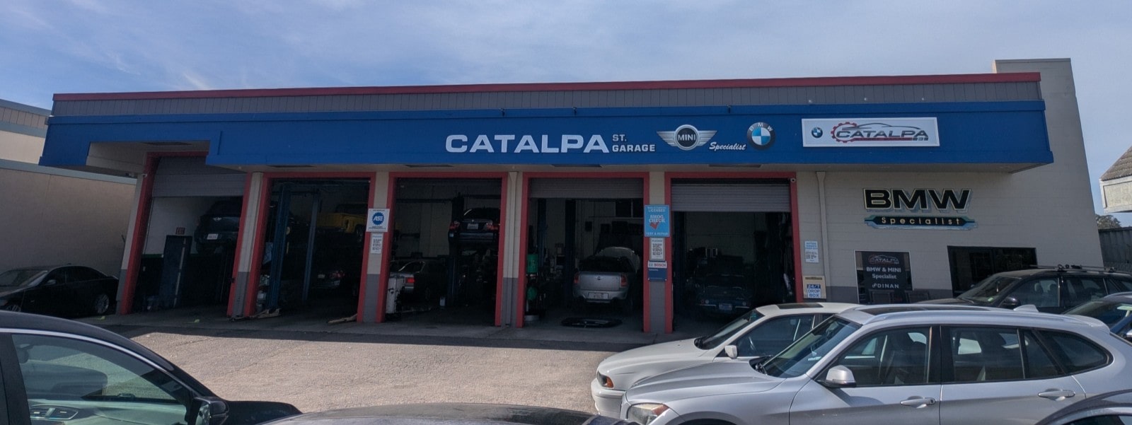 Exterior view of Catalpa Street Garage with multiple service bays and parked cars.