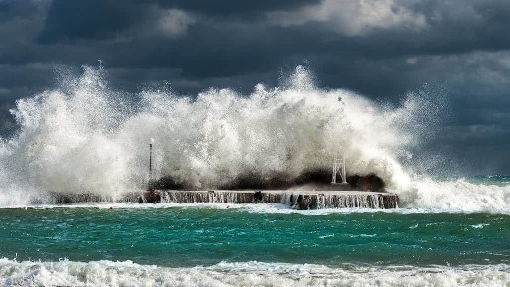Winter swells crashing on a jetty