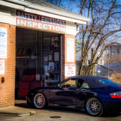 Car parked at C&H Automotive safety and emissions inspection station.