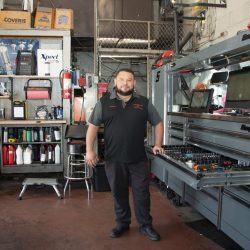 Skilled auto technician at C&H Automotive workshop with tools and equipment.
