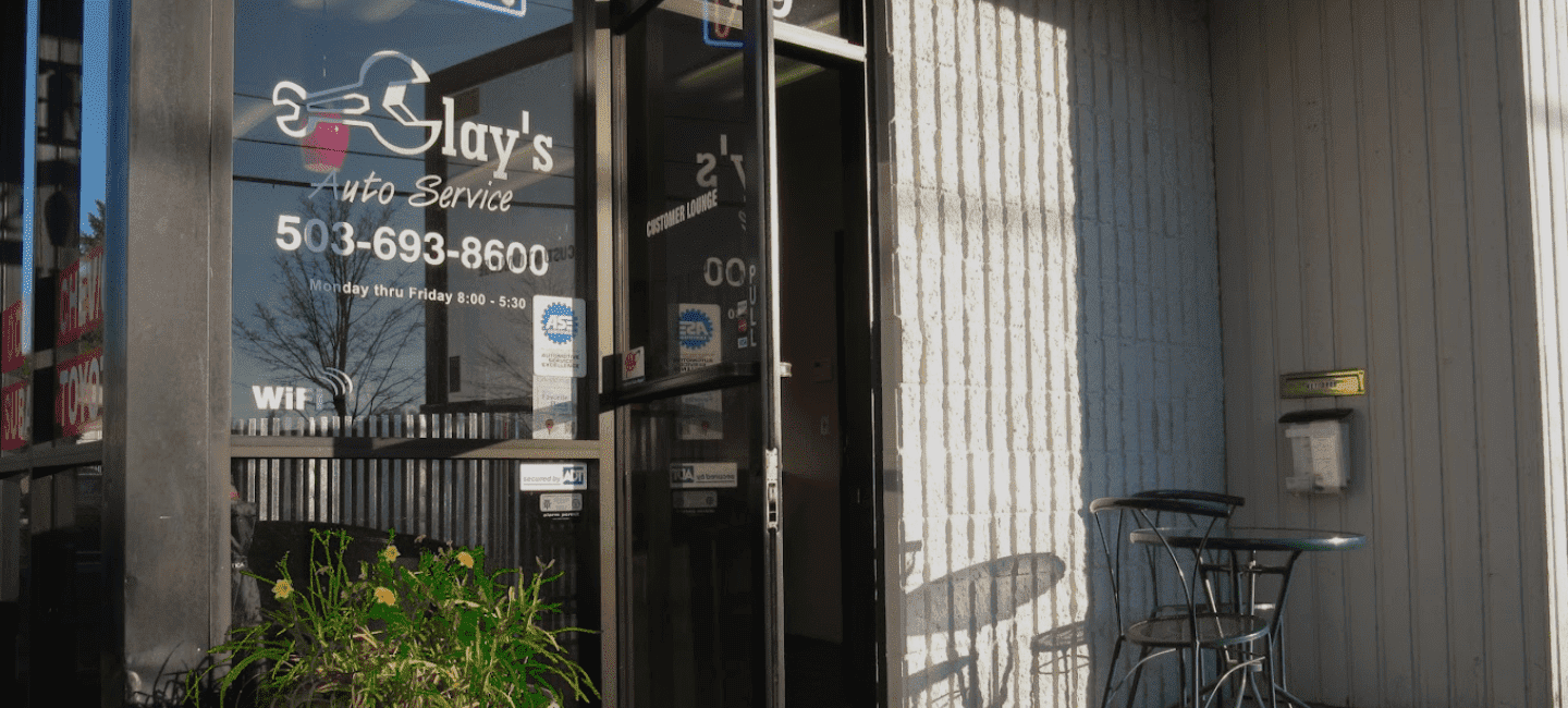 Exterior view of Clay's Auto Service shop with signage and glass door.