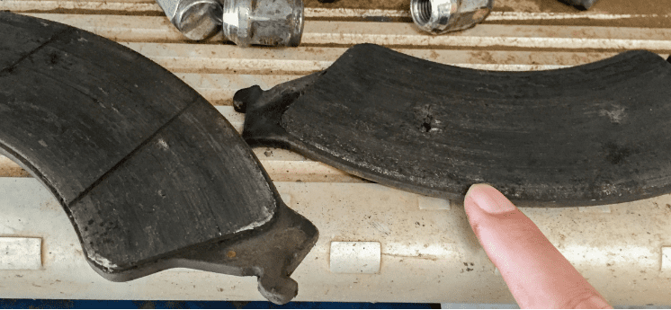 Brake pad wear inspection for vehicle maintenance and safety.