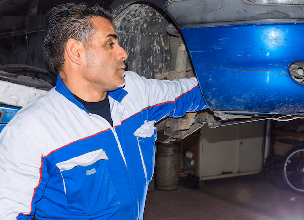 mechanic-repairing-car-repair-shop