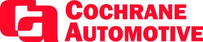 Modern automotive repair shop with technicians working on vehicles.