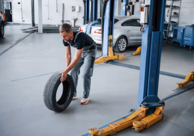 mechanic rolling a tire