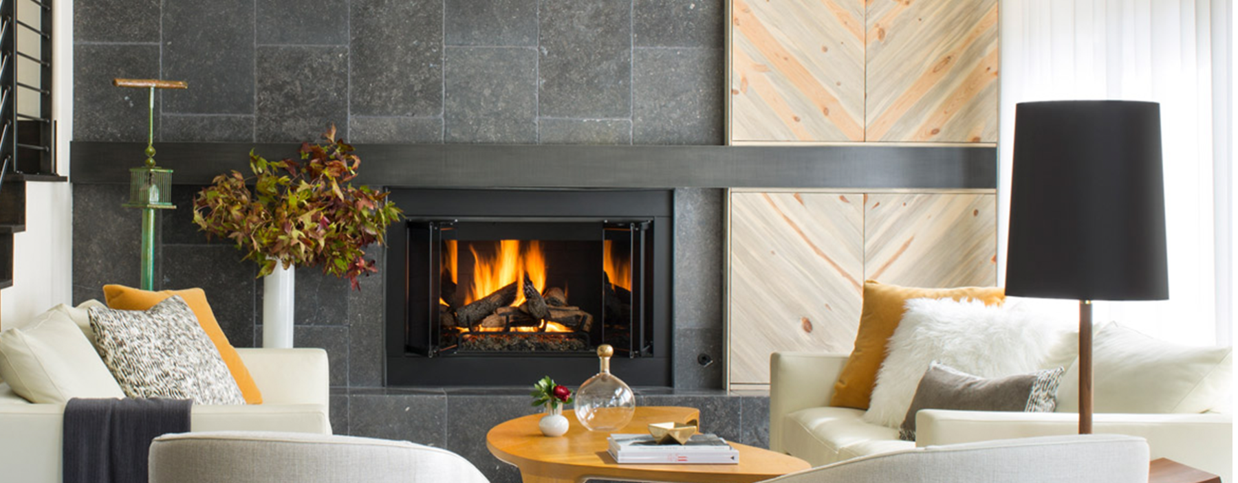 Fireplace with modern stone and wood accents in stylish living room.