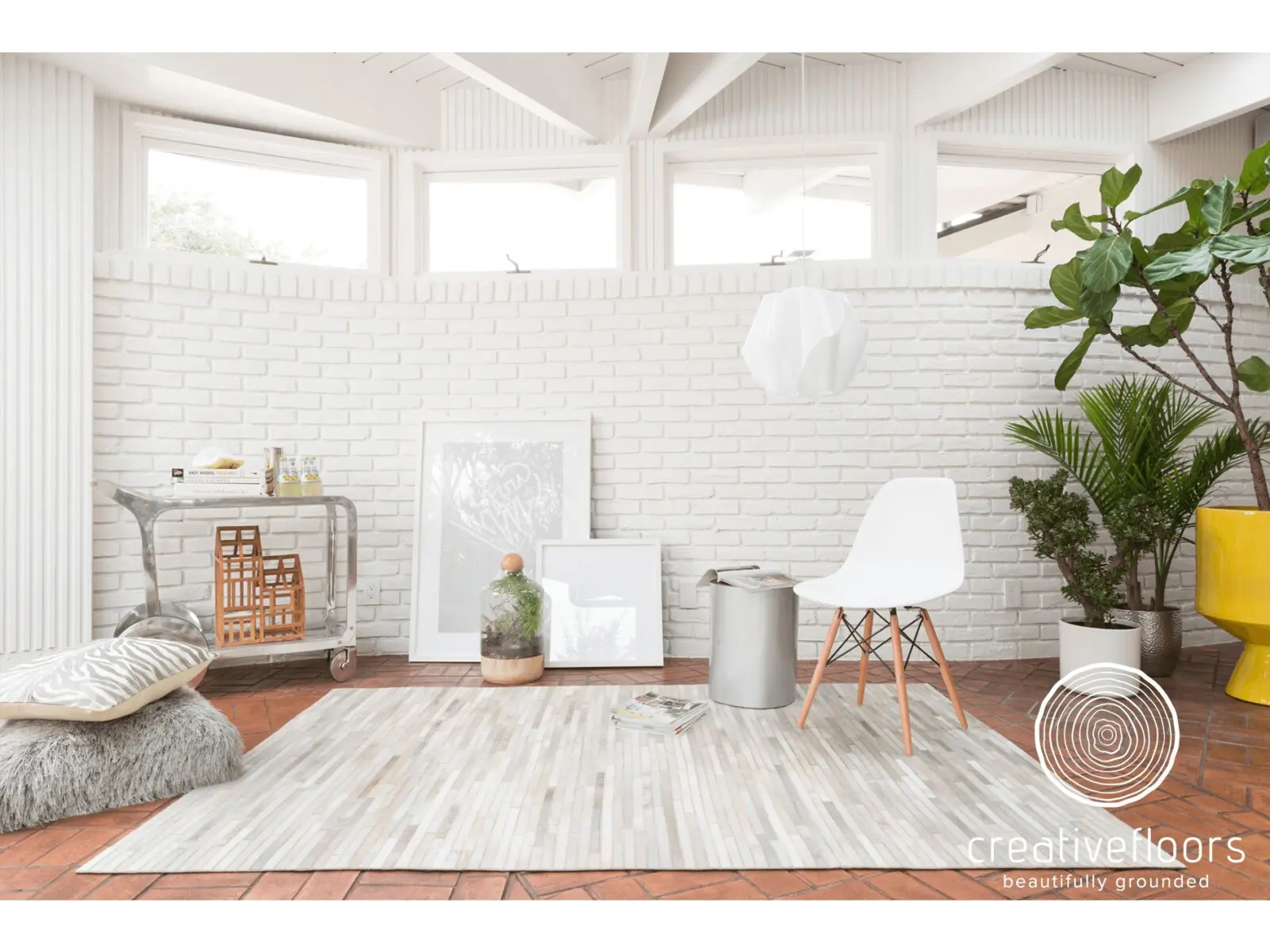 Soft white modern room with wood and tile floors, natural light, and indoor plants.