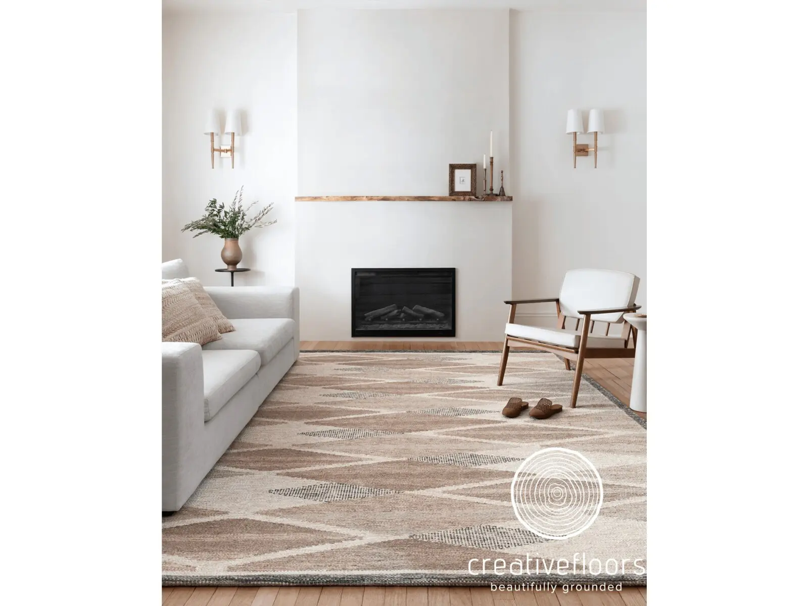 Soft beige and cream patterned area rug in modern living room with white sofa and wooden accents.