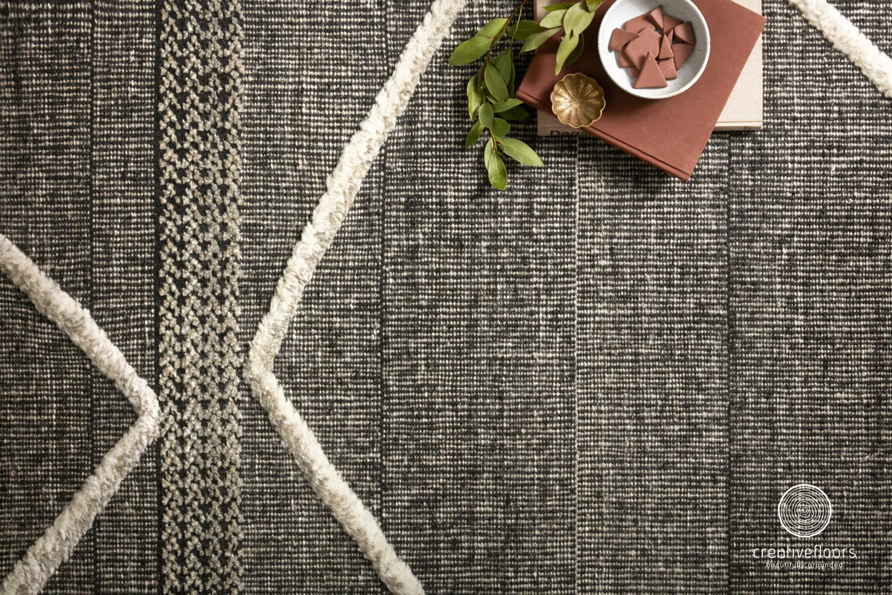 Intricate woven carpet featuring modern geometric patterns and neutral tones for stylish interior flooring.