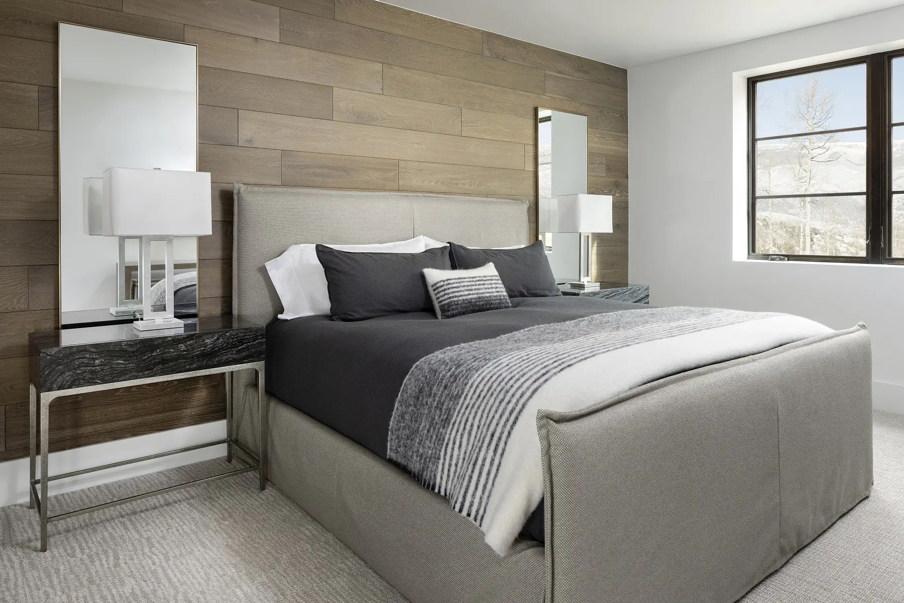 Luxurious bedroom with modern hardwood flooring and contemporary decor for home renovation.