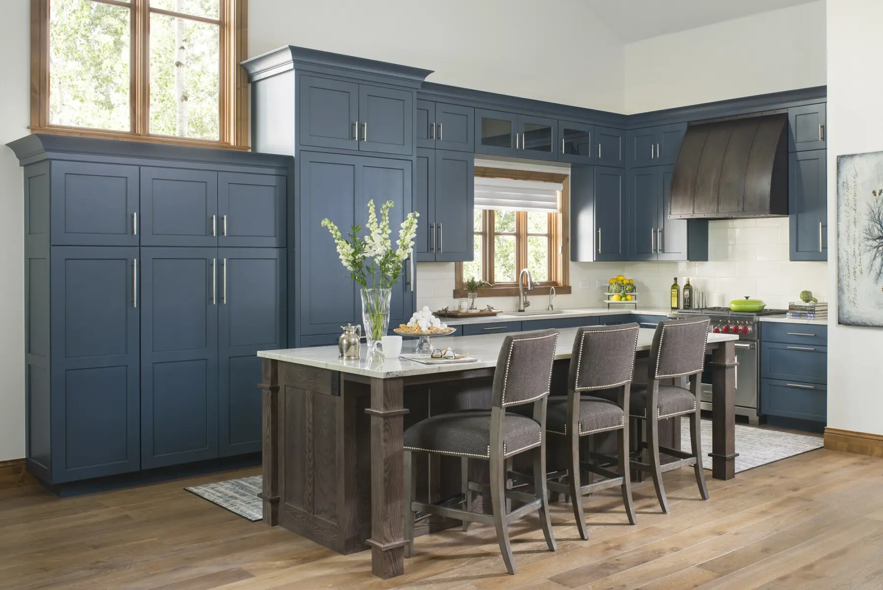 High-quality kitchen with custom blue cabinetry, farmhouse island, and modern appliances.