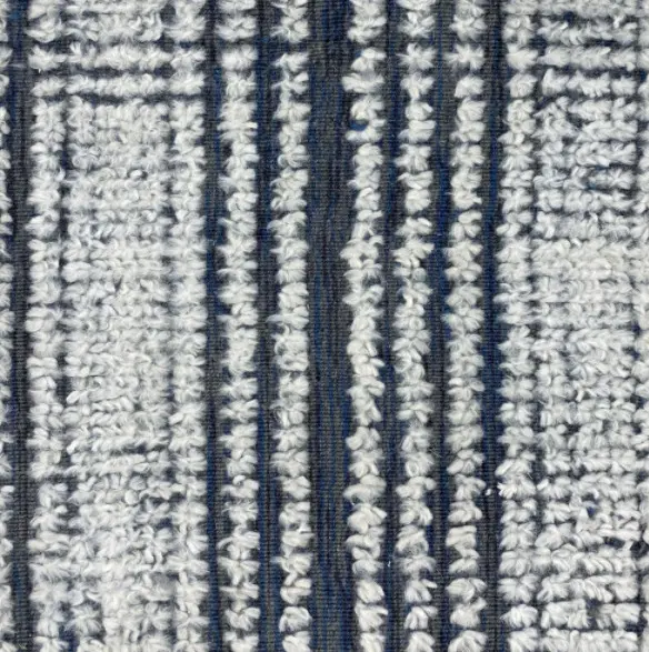 Soft textured patterned rug with striped design in navy and white.