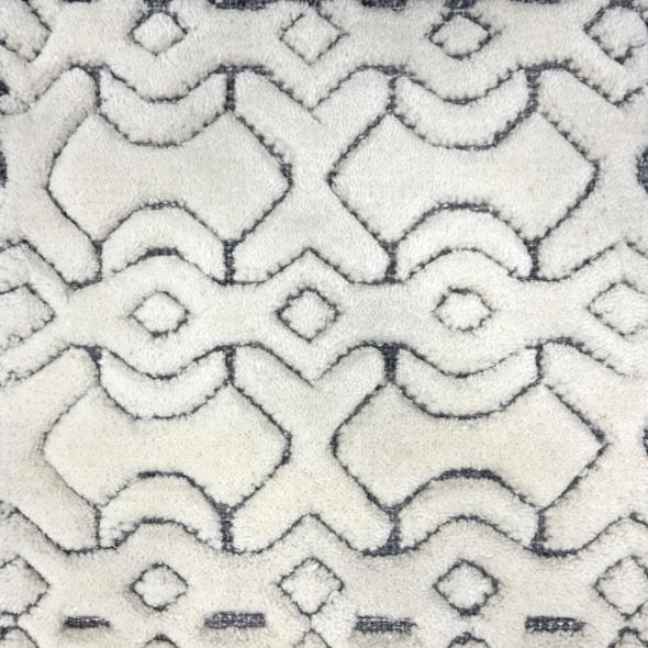 Soft white area rug with black geometric patterns, perfect for contemporary and modern home decor.