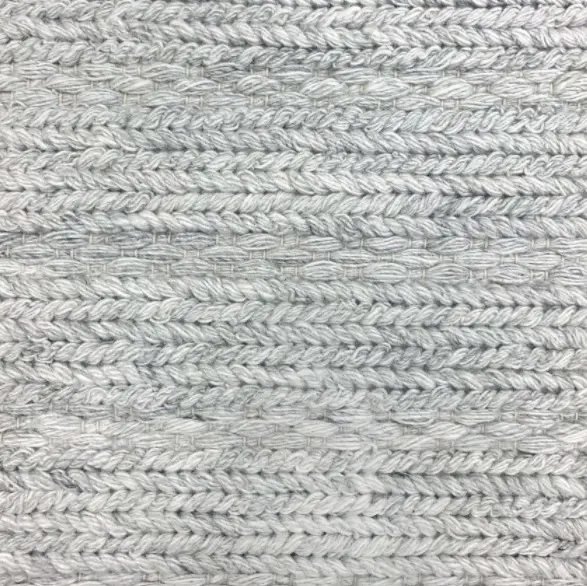 Thick gray braided carpet texture for flooring or decor purposes.
