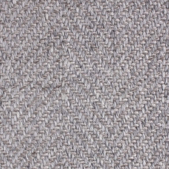 Soft beige herringbone carpet flooring with textured woven pattern.