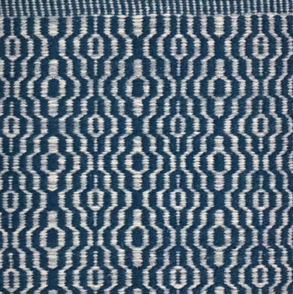 Blue and white geometric patterned rug for modern flooring solutions.