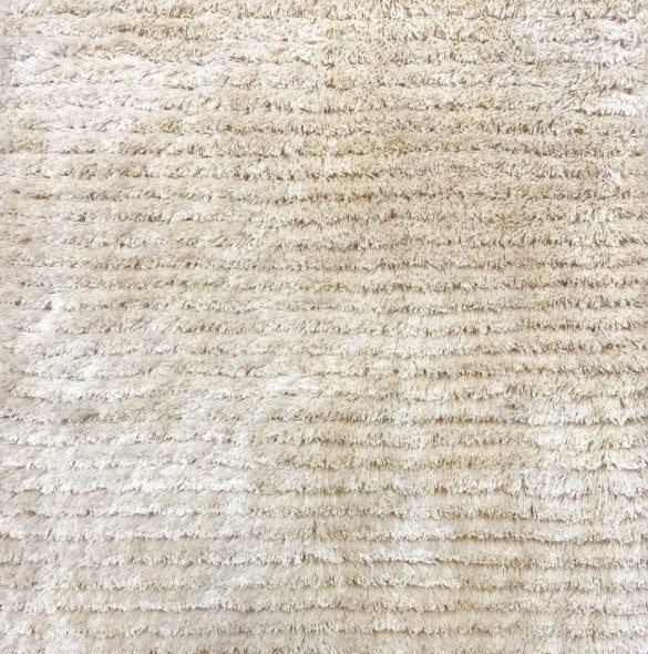 Soft, plush beige shag carpet for luxurious flooring and home décor.