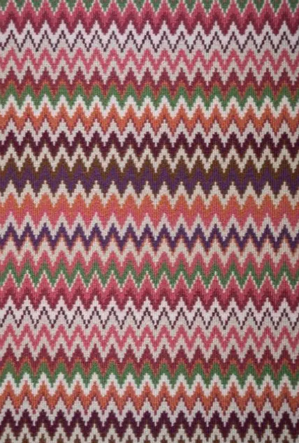 Vibrant zigzag patterned area rug in multiple colors for home decor and flooring solutions.