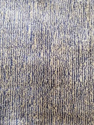 Textured beige and blue patterned carpet with modern design, ideal for residential and commercial flooring solutions.