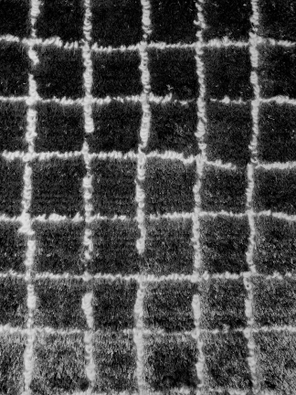 Impression of a plush black and white checkered carpet with a soft texture and grid pattern.