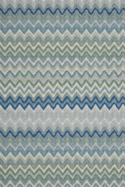 Soft blue, green, and gray zigzag patterned carpet for modern interior design.