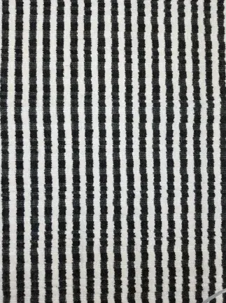 Black and white striped carpet flooring pattern for modern interior design.