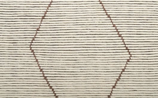 Smooth wooden flooring with geometric inlay design for residential or commercial spaces.