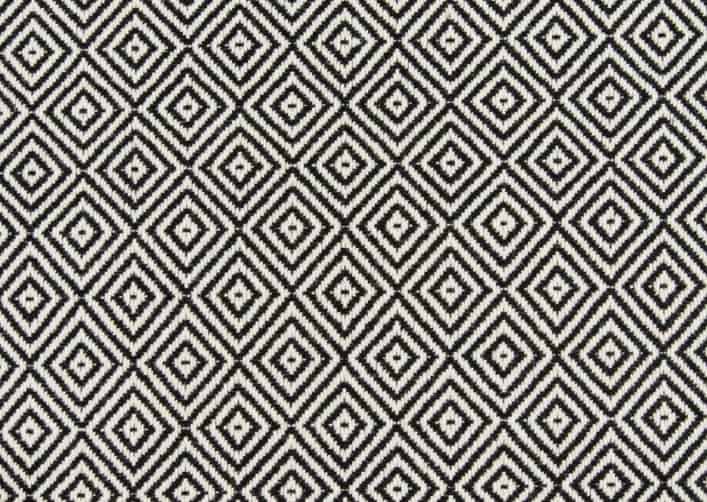 Black and white geometric patterned carpet for interior design flooring installations.