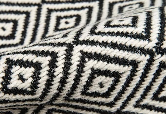 Black and white geometric patterned rug for interior design and flooring.