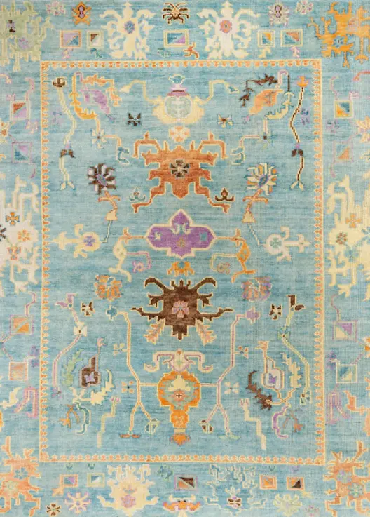Vintage floral area rug with intricate patterns in pastel shades and vibrant accents.
