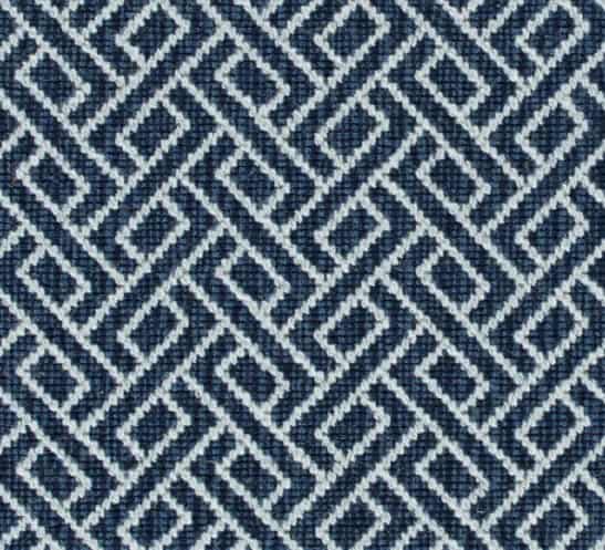 Vibrant blue geometric patterned carpet for modern interior design.