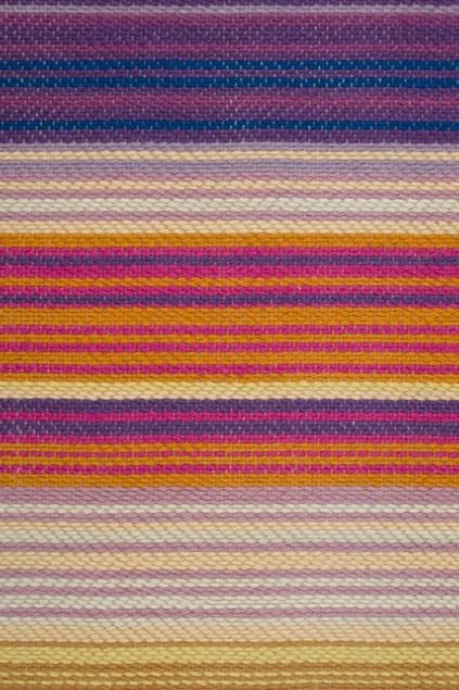 Colorful striped woven rug showcasing high-quality craftsmanship for home decor.